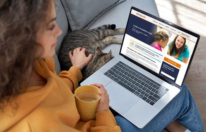 Woman using a laptop to search careers on the UVA website
